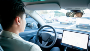 Man sitting in driverless car