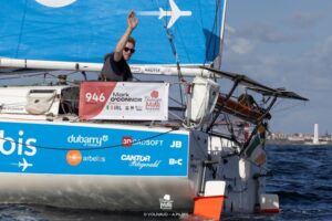 Mark celebrating on his blue sailing boat